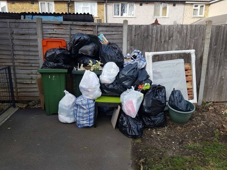 Dalston street with a skip container placed on the sidewalk