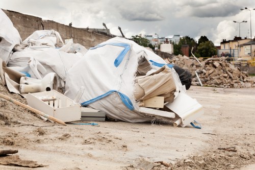 Skip Hire Dalston branded skip and crew member preparing site