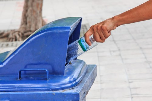 Homeowner loading a skip with household waste