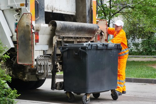 Construction workers loading a builders skip in Dalston